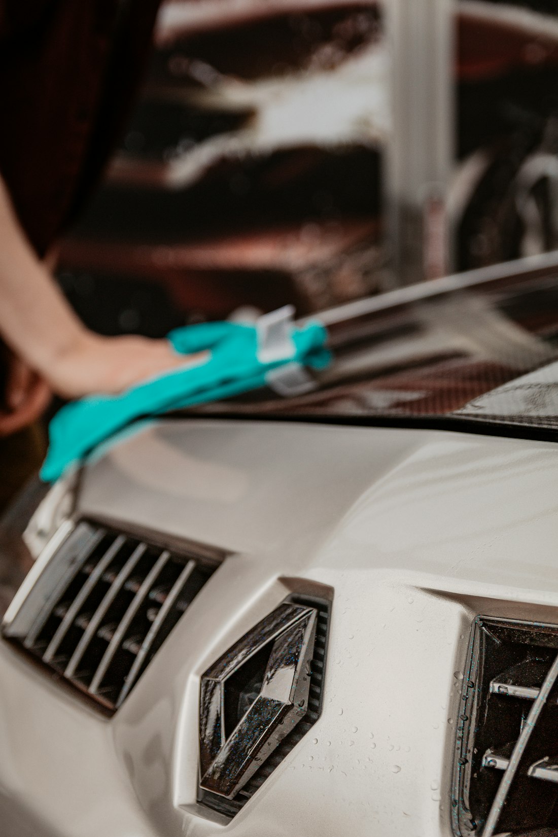 Professional finishing a vehicle as part of the dealership service